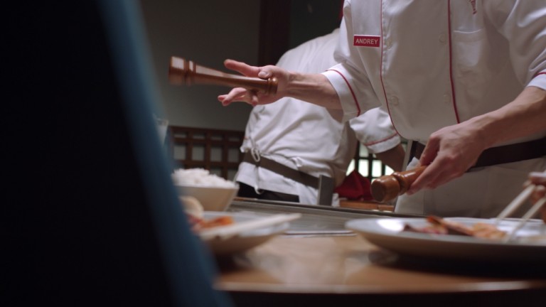a chef holding a wooden mallet