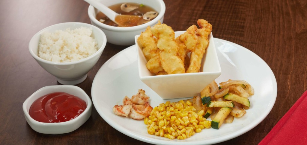 a plate of food with a bowl of soup and a bowl of soup