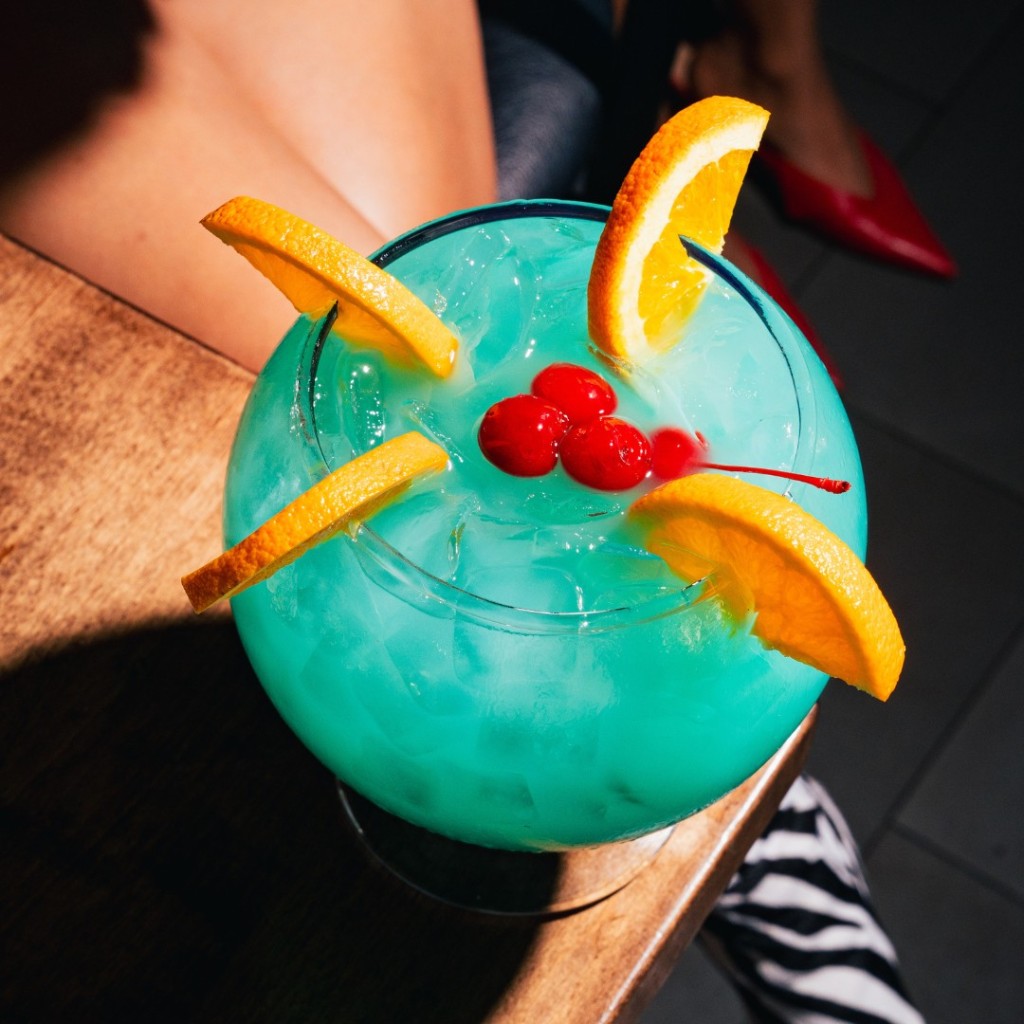 Our famous Punch Bowls are a can't-miss for those over the age of 21. Share one the next time you visit our location. The Baby Blue Ocean, pictured here, is a tropical blue concoction with RumHaven, New Amsterdam Pineapple Vodka, sake, blue curaçao and tropical fruit juices.