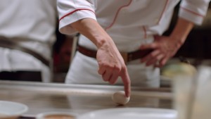 a chef pointing at a white egg