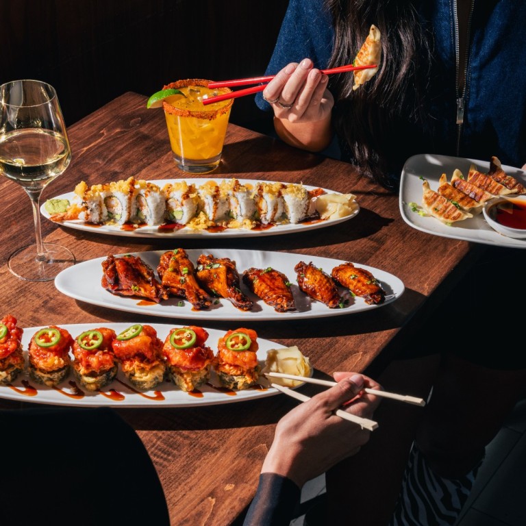 a group of people eating sushi